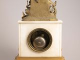 an image of a clock with a statue on top of it