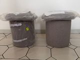 two trash cans sitting next to each other on the floor