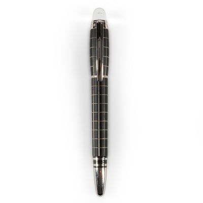 a close up of a pen on a white surface with a white background