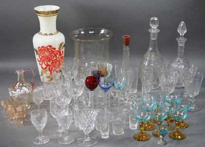 a lot of glasses and vases sitting on a table