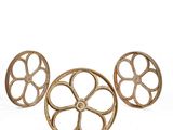 three antique cast iron wheels on a white background