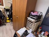 an image of a cluttered room with a desk and a chair