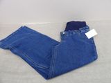 a pair of blue jeans laying on top of a bed