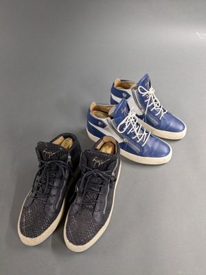 two pairs of blue and white sneakers sitting next to each other