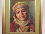 painting of a woman in a headscarf in a frame on a shelf