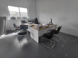 une photo d'un bureau vide avec un bureau et des chaises