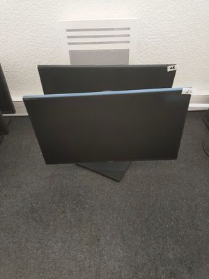 a computer monitor sitting on top of a desk next to a computer monitor