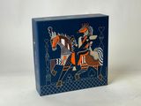 an image of a blue box with a picture of a man riding a horse