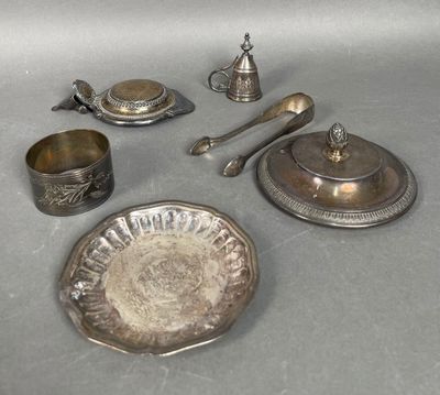 a silver plate with silverware on it and silver spoons