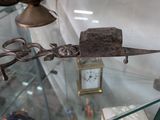 une vitrine en verre contenant une horloge et divers objets