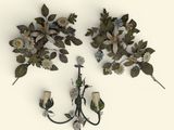 two wall sconces with flowers and leaves on them