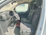the interior of a car with the door open and the driver ' s seat down