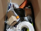a cardboard box filled with assorted items including a hose