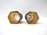 pair of brown and white ceramic salt and pepper shakers on a white background