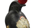 an old helmet with a red hat on top of it