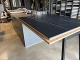 a table with a black top in a room