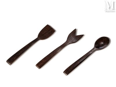 three wooden spoons and a spatula sitting next to each other