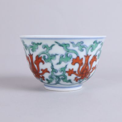 a white bowl with a red and green design on it