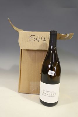 a bottle of wine that is sitting next to a box