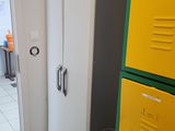 yellow and grey lockers in a room with a white tiled floor