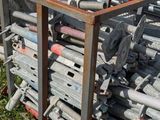 a pile of metal pipes sitting in the grass
