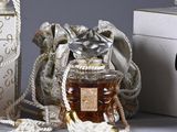 a small bag of honey next to a bottle of honey