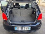 the back of a car with its trunk open on the street