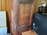 a large wooden cabinet with a tv on top of it