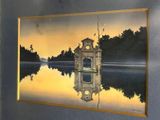 a picture of a clock tower on the water