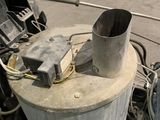 a large metal tank with a metal pipe sticking out of it