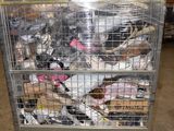 a metal cage filled with many different types of birds