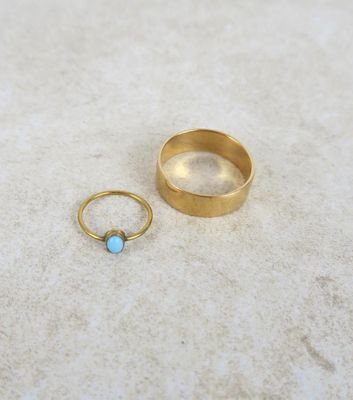 un gros plan sur deux bagues en or ornées d'une pierre turquoise