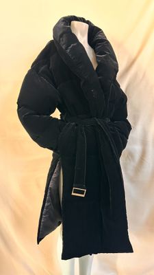 the coat is black and has a gold buckle on the collar