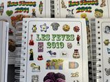 many notebooks with stickers on them sitting on a table