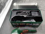 a green box with tools in it sitting on the floor