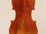 an old violin with a wooden back and a long neck