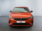 the front view of an orange opel parked in a showroom
