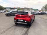 a red car that is parked in a parking lot