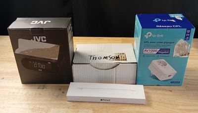 three boxes of nintendo wii games sitting on a wooden table