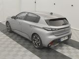 the rear end of a silver car parked in a garage