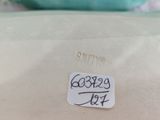 a close up of a pillow with a sticker on it