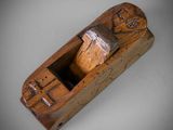an old wooden plane with a wooden handle on a white surface