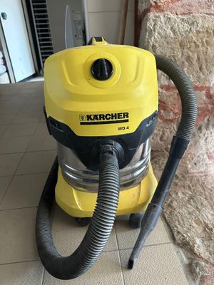 un gros plan d'un aspirateur jaune et noir posé sur un sol carrelé