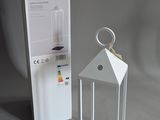a white lantern that is next to a white box