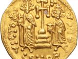 a close up of a gold coin with a group of people on it