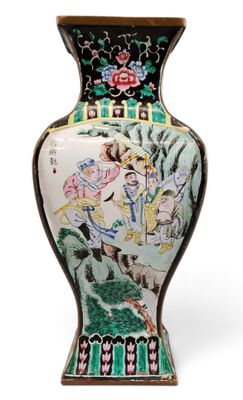 a vase with a painting on it sitting on a table