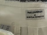 the label of a white dress with a black and white design on it