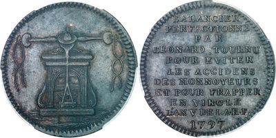 a close up of a coin with an image of a bell on it