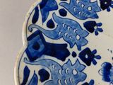 a blue and white plate with animals on it
