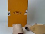 tan leather slippers with open toe and a box on a white surface